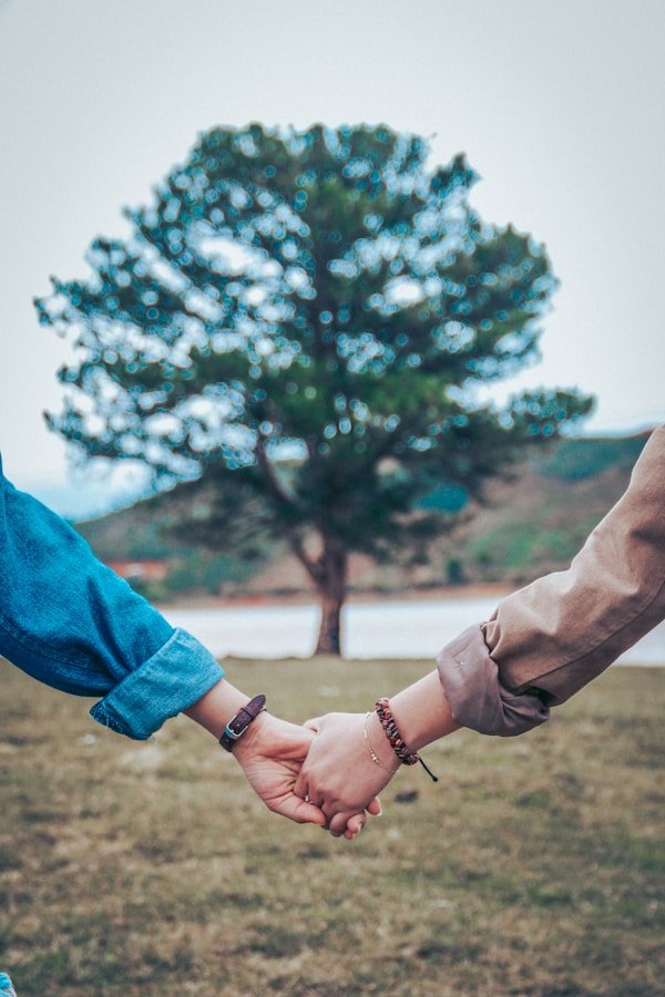 Two people holding hands